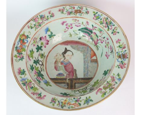 A Canton famille rose basin the well painted with a beauty on a balcony within scattered flowers and precious objects, gilt r