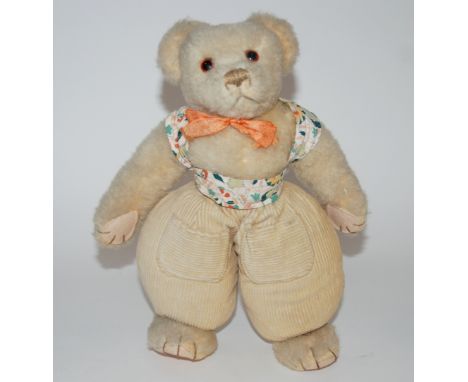 A Merrythought Dutch Teddy Bear brown stitched nose, mouth and claws, corduroy integral baggy trousers with pockets, felt pad