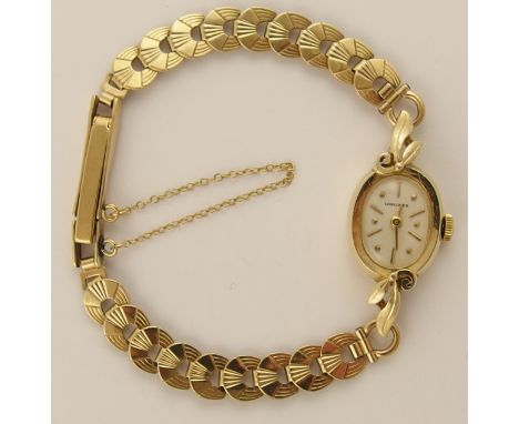 A 14ct ladies Longines watch with a cream colour dial with baton and dot numerals and gold coloured baton hands, with a 9ct s
