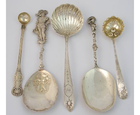 A continental silver serving spoon with London import marks, the shell shape bowl with floral embossed patch, the finial mode