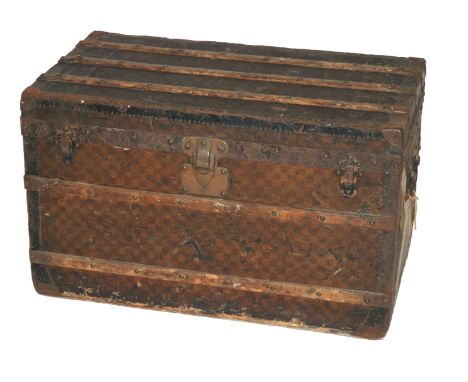 A Louis Vuitton cabin trunk with three lift out drawers, with label and travel labels for Chamonix, Lausanne, metal hinged ca