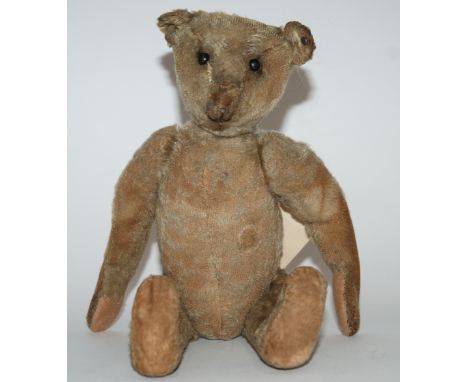 An early Steiff Teddy Bear with black boot button eyes, pronounced muzzle, swivel head, jointed elongated limbs with replacem