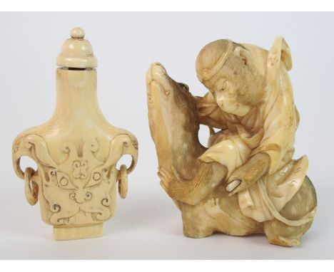 A Japanese ivory okimono of a monkey seated on a deer, 7cm high and an ivory snuff bottle carved with tao tie masks and ring 