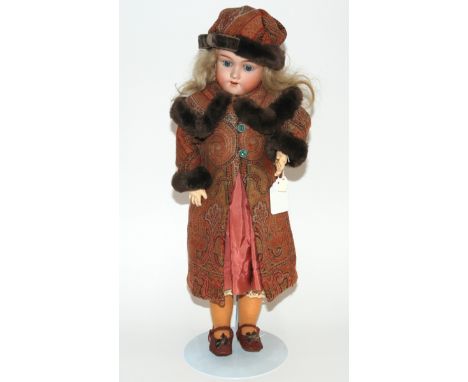 A Max Handwerck bisque-headed doll with open and close blue eyes, open mouth and painted features, jointed body, the head imp