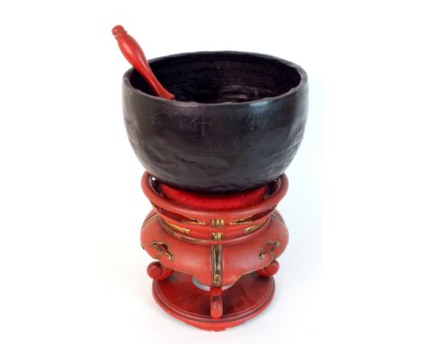 A Chinese gong on red and gold lacquered stand with pierced scroll panels, with beater, 30cm high
