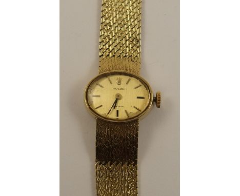 A 9ct ladies Rolex Precision with patterned integral strap, oval cream dial with baton numerals and hands, dial size approx 1