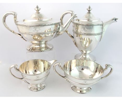 A four piece silver tea service by James Ballantyne & Son, Glasgow, 1910, of squat circular form, the looping handles termina