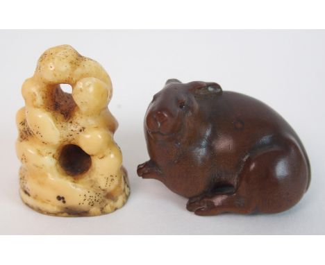 A Japanese fruitwood netsuke of a hare signed, 3.5cm wide and a bone netsuke rock carving, 3.5cm high (2)