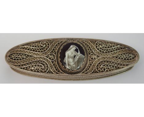 A filigree box of oval shape the hinged lid set with an enamel plaque depicting a lady in classical dress, unmarked, 10cm x 3