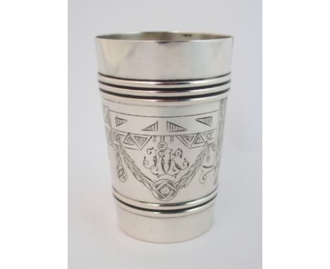 A Russian silver vodka cup maker's mark NG and marked '84, of tapering cylindrical form with raised banding top and bottom en