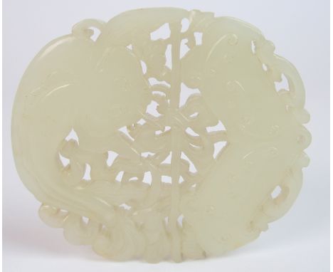A Chinese jade pendant carving of a catfish above a scroll divided by a ribbon tied branch, 7.2cm high