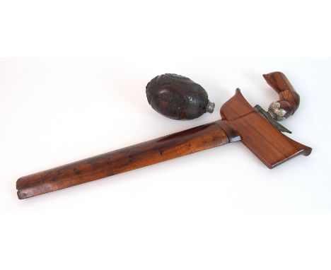 A Malaysian kris in rosewood scabbard 44cm long and a Napoleonic carved nut powder flask, 11cm high (2)