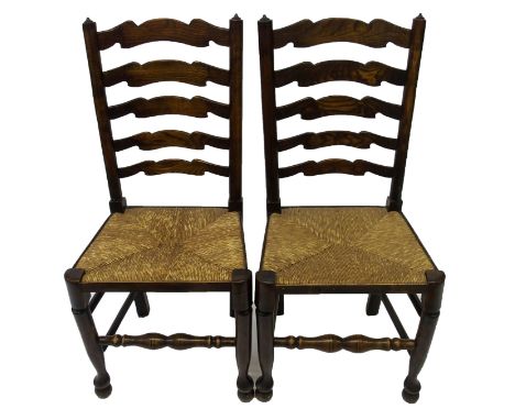 A set of six ash ladder back dining chairs with five spars above rush seats and on ring turned legs (6)