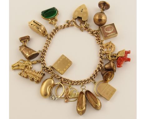 A 9ct gold curb link bracelet with a heart shaped clasp  and 15ct gold 9ct charms and a German example in 14ct, to include a 