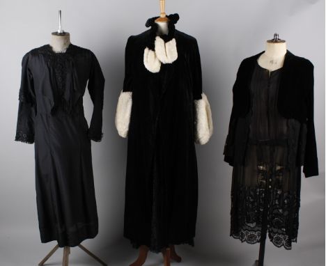A black 1930s velvet evening coat with white fur trim; together with an Edwardian black dress, a 1920s black velvet day dress