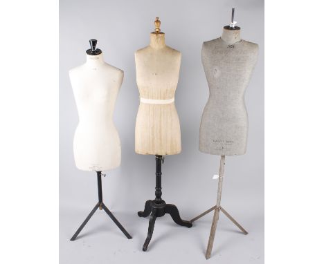 A Yugin & Sons female mannequin with a grey linen torso on a metal base; together with a 1920s female mannequin with a wooden