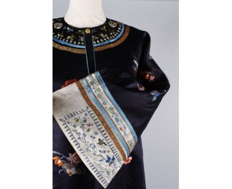 A late 19th/early 20th century Chinese silk embroidered coat with a turquoise lining, the coat is embroidered with a design o