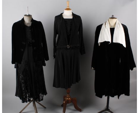 A 1920s black velvet evening coat trimmed with white fur, a 1930s black georgette and lace dress, a black dress with devore d