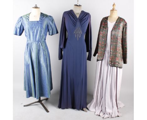 A 1930s navy blue crepe evening dress, with a 1940s pale green coat/dress with velvet trim, a pale mauve full length dress, a