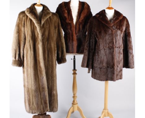 A three-quarter length musquash jacket, a mid-brown vintage mink coat (considerable damage to the lining and hem), a fox fur 