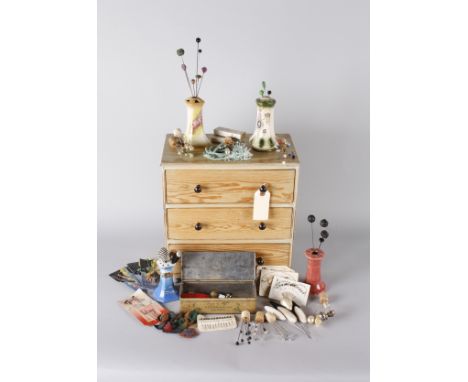 Four ceramic hat pin holders, with a collection of hat pins of varying lengths and types, leather brooches, diamante hat deco