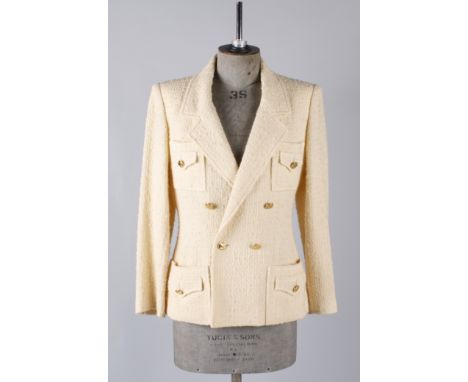 A 1990s Chanel Boutique buttermilk coloured boucle long-line double-breasted wool jacket, 'Chanel Paris' gold metal buttons, 