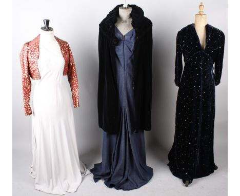 A 1930s Harrods pale grey silk evening dress; with a 1920s black velvet coat, a 1930s red and gold evening jacket, a 1930s fu