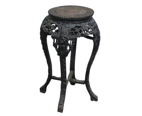 A Chinese carved hardwood and pink marble circular Plant Stand, circa 1900, probably Padouk Wood, with foliate carved frieze,