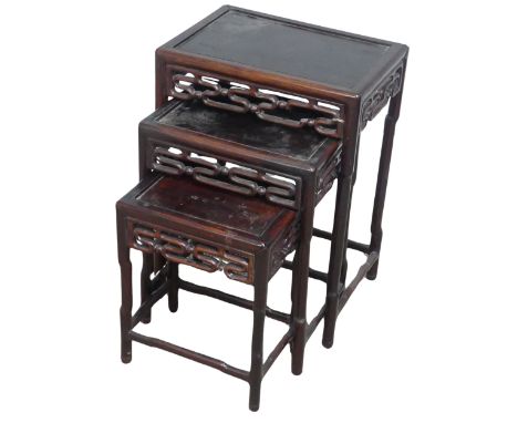 A Chinese nest of three hardwood Tables, probably huanghuali, circa 1900, rectangular tops above moulded scroll friezes, (lar