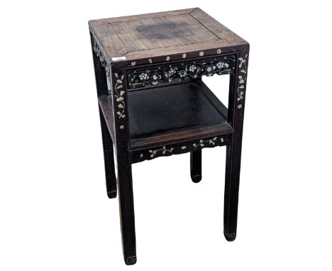 An antique Chinese hardwood and mother of pearl inlaid two-tiered side Table, square top above carved, pierced and inlaid fol