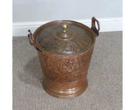 An Arts and Crafts hammered copper Bucket, embossed with Art Nouveau inspired stylised flowers and leaves, H 40 cm. 