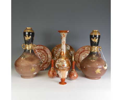 A pair of antique Japanese Satsuma Vases, of bottle form, with dark brown and black ground decorated with flying gilded birds