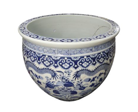 A large decorative antique Chinese blue and white Jardiniere, decorated with dragons amongst chrysanthemums, heavily damaged 