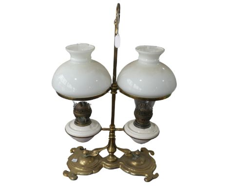 A Victorian student's desk double Oil Lamp, with opaque glass shades above ceramic reservoirs, marked 'Eltex', raised on bras