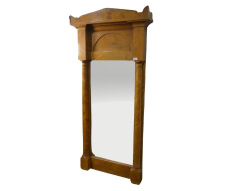A late 19th century Biedermeier pillar Mirror,&nbsp;possibly satinwood or maple, the shaped cornice above arched panel and mi