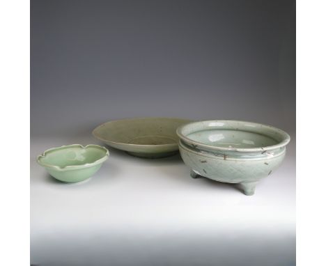 A large antique Chinese celadon Charger, hairline cracks and firing fault to the foot, D 32cm, together with a Chinese celado