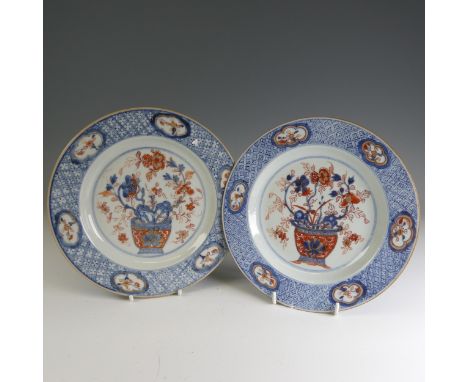 A pair of 18thC Chinese rose imari porcelain Plates, decorated to the well with flower basket and enclosed within scale borde