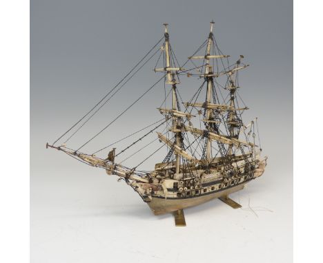 19th century Napoleonic Prisoner of War carved bone model of a three mast thirty-six gun Frigate, on later brass supports, in