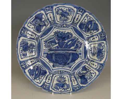 A 17thC Chinese blue and white kraak type porcelain Plate, decorated to the well with flower basket, enclosed within border o