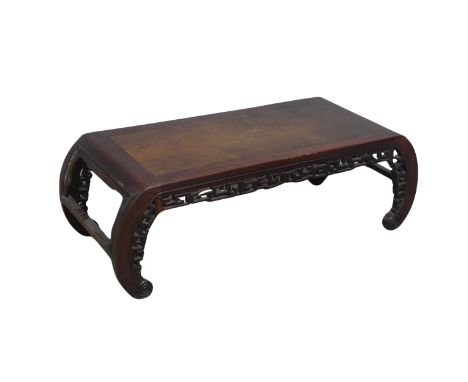 A Chinese carved hardwood opium / coffee Table, top set with rectangular panel, above scrolled and pierced frieze, raised on 