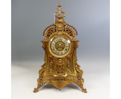 A large antique French ormolu style gilt metal Mantel Clock, enameled Roman numeral dial, encased in convex glass,&nbsp;highl
