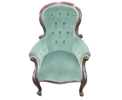 A Victorian walnut framed upholstered Armchair, hoop button-back above scroll walnut arms and serpentine seat, raised on scro