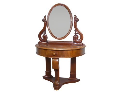 A Victorian mahogany demilune dressing Table, bevelled oval mirror flanked by carved scroll supports to either side, above de