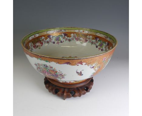 A late 18thC Chinese mandarin palette Punch Bowl, decorated in colouful flora enamels within orange scale border, central dep