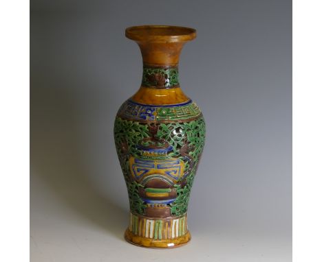 A Chinese double walled reticulated Vase, of baluster form, in ochre ground with blue and green colouration, intricately reti