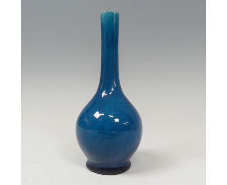 An antique Chinese monochrome Bottle Vase, of blue colour, on potted foot, firing faults to foot, H 15.5cm.Provenance - The D