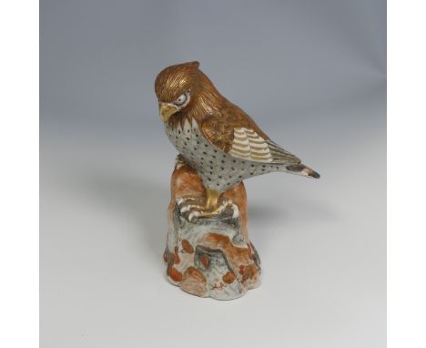 A 19thC Japanese kutani porcelain sculpture of a Bird of Prey, decorated in the typical palette, six character mark to base, 