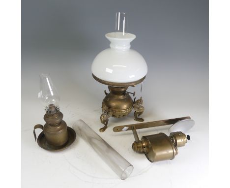 An antique brass tripod-base Oil Lamp, base with dragon style supports, H 42.5 cm, together with two other brass Oil Lamps, o