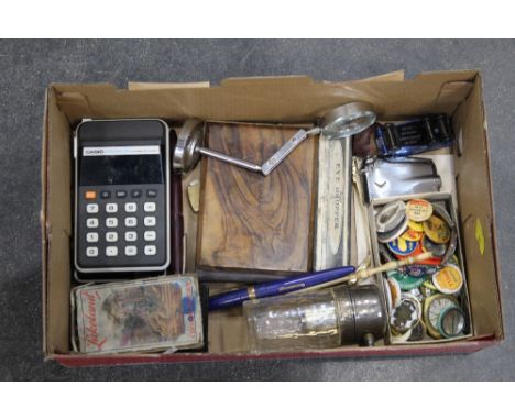 Box of vintage badges, calculator, magnifier, pens, lighter, etc. 