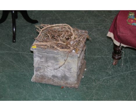 A square stone garden planter with floral decoration, measuring 28 cm tall  